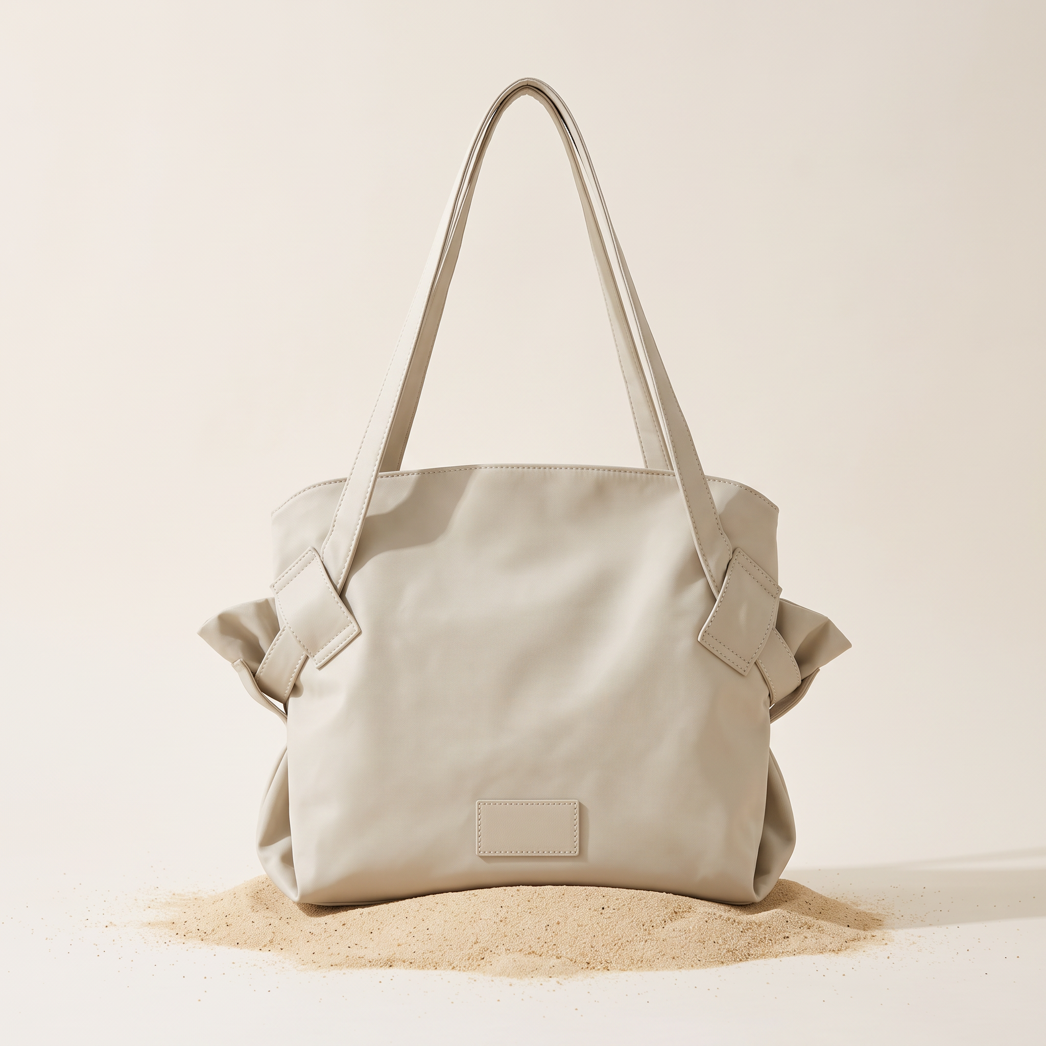 The Pilo Bag in Stone on sand