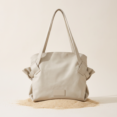 The Pilo Bag in Stone on sand
