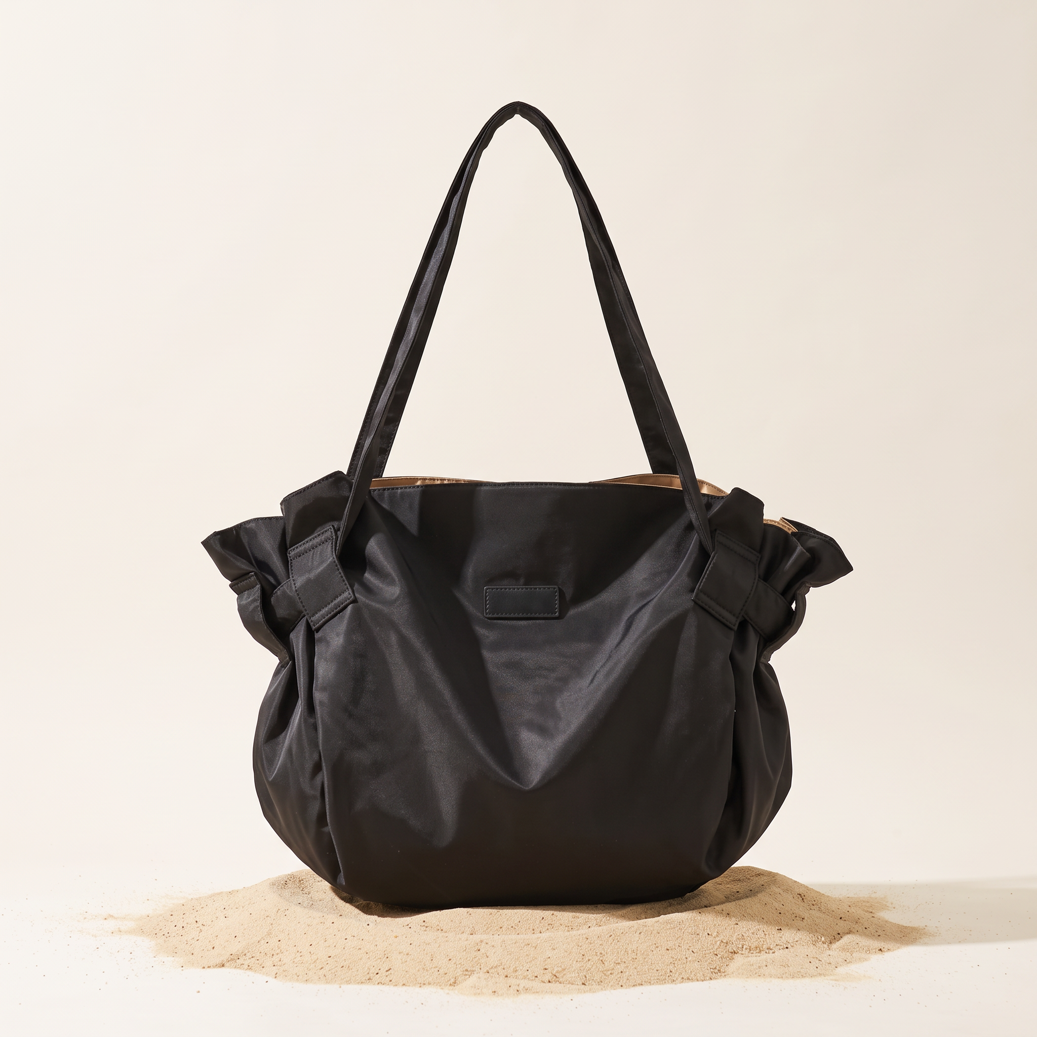 The Pilo Bag in Black on sand