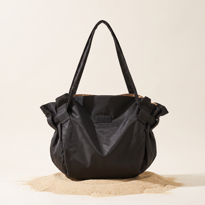 The Pilo Bag in Black on sand